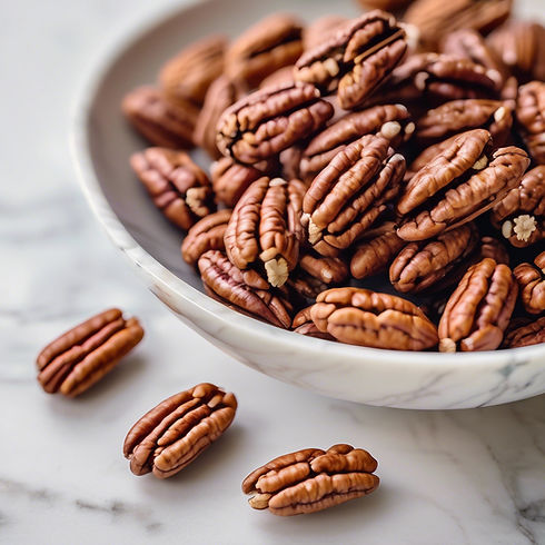 pecans on a marble countertop in a bright, light, and airy setting with maybe some light o