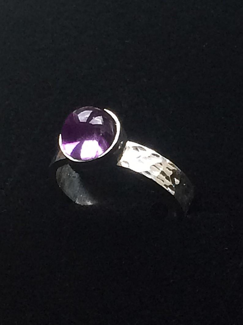 Thumbnail: Sterling Silver Vivid Amethyst Cabochon Ring on a Hammered Effect Silver Band