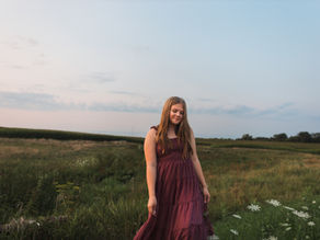 Aubriana smiling and enjoying a natural senior photography session in Northwest Illinois
