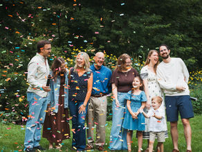 Brianna’s extended family smiling and embracing during a relaxed family photography session in Northwest Illinois