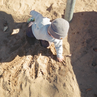 Child playing outdoors captured in a candid family photography style