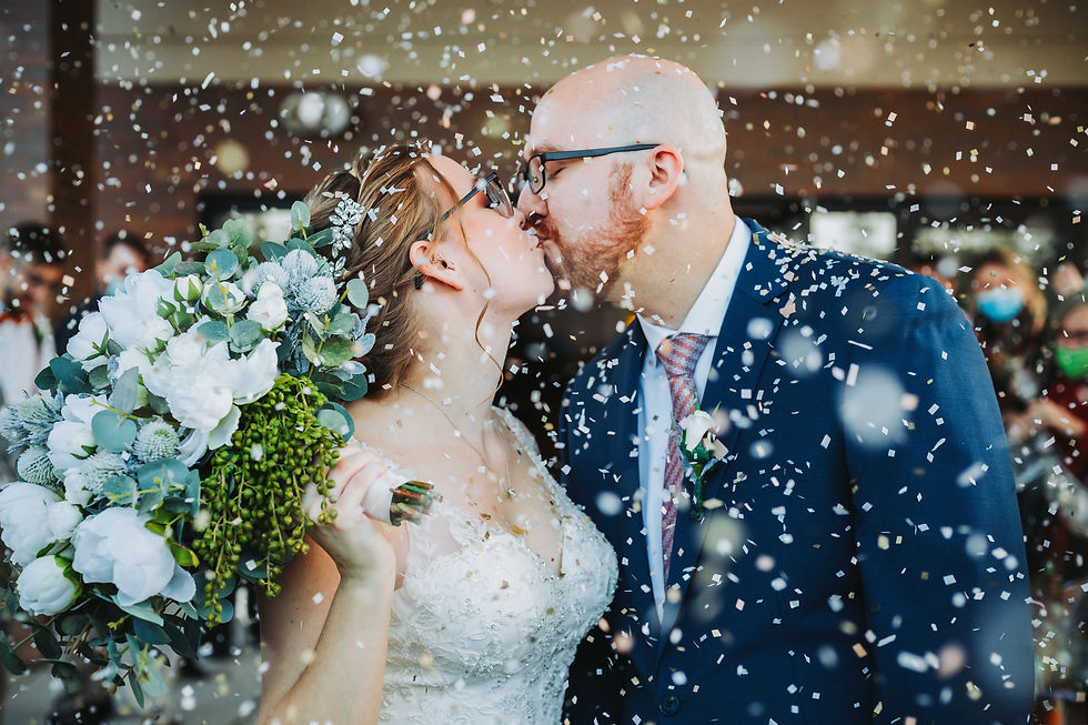 couple kissing to celebrate matrimony under confetti