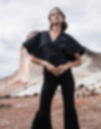 Women in black outfit standing in the desert