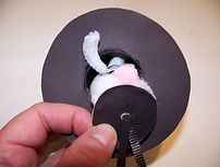 Kidfunideas.com Rabbit out of the hat magic hat picture of inserting the rabbit into the hat
