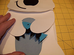 Kidfunideas.com polar bear paper bag puppet picture of attaching the fish to the hand