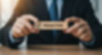 Businessman in suit holds a wooden block labeled PROACTIVE with a checkmark in a bright office.