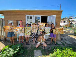 Students holding eco-printed and naturally dyed fabrics at Tinctorium Studio during a Workshop
