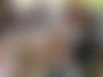 Iris looking into the camera surrounded by teachers who are working on the workshop materials