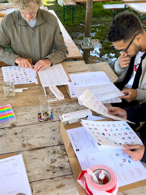 Three teachers working with the workshop materials that exist of worksheets and stickers