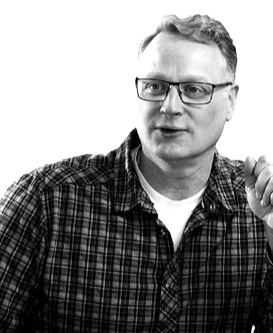 A headshot of Tom Frisby