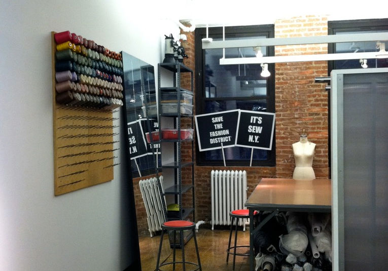 Fashion studio space with movable partitions and track lighting for showroom display.