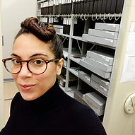 Profile photo of Jasmine Soliman standing in front of archive stacks 20190415