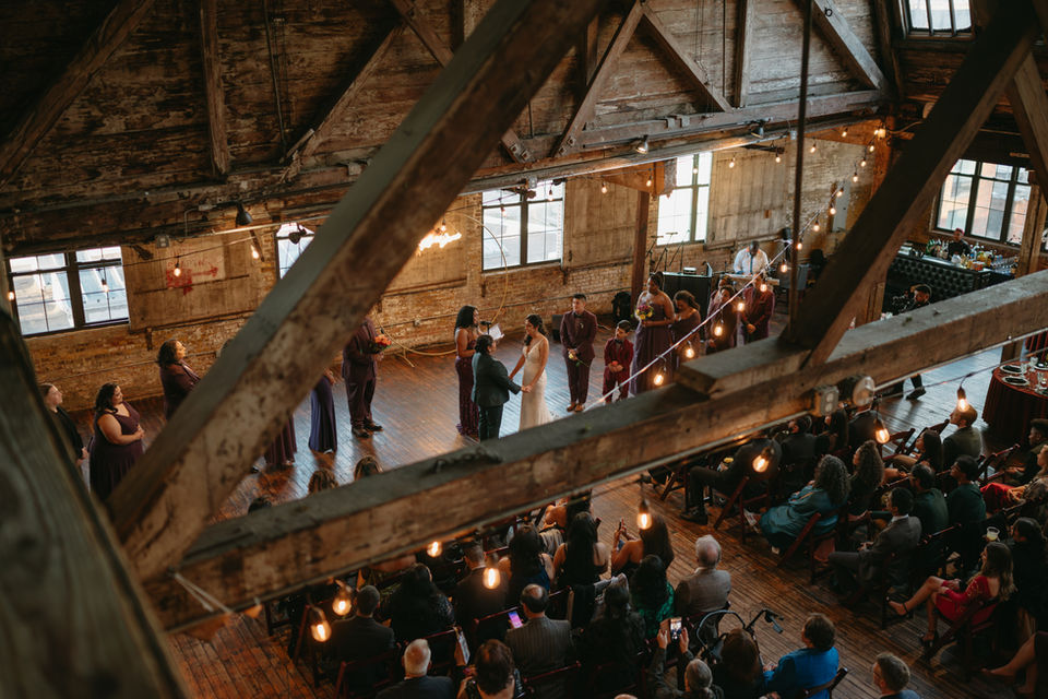 bride and bride getting married at the altar family around them 