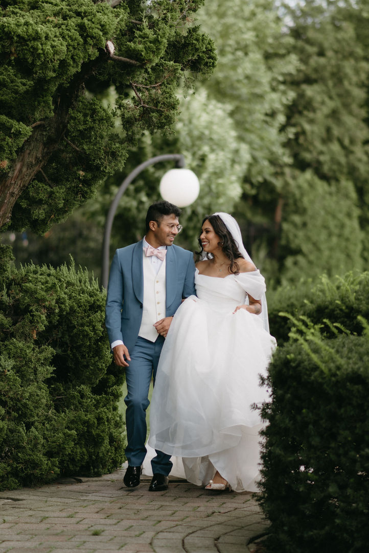 bride and groom looking at each other and walking