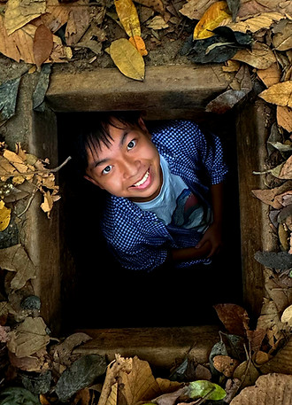 Tour guide crawling in the Cu Chi Tunnel
