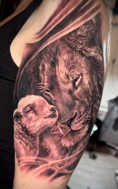 Black and Grey Lion and Lamb Tattoo on arm