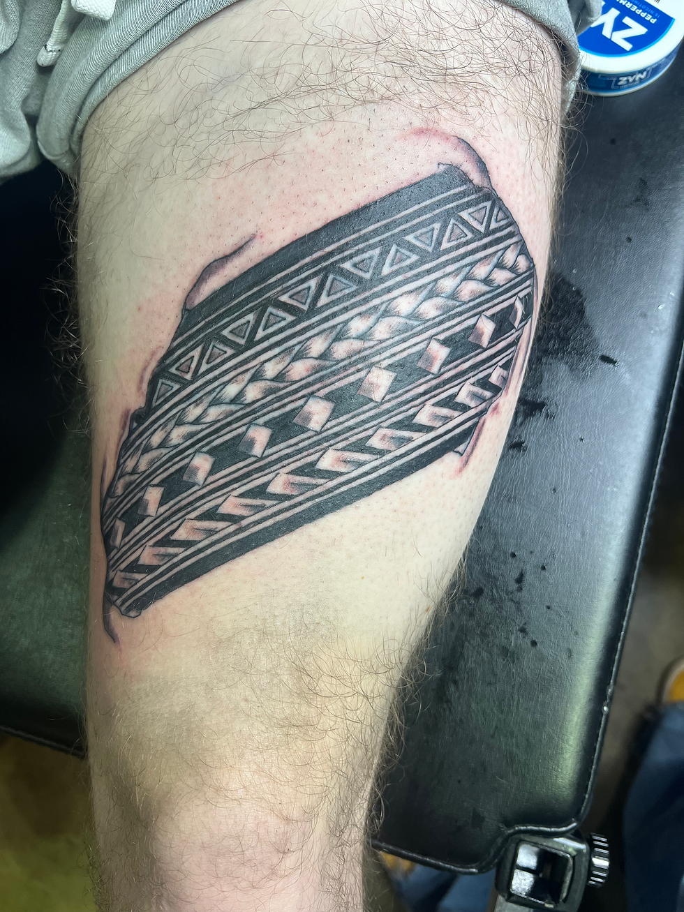 black and grey tire tattoo