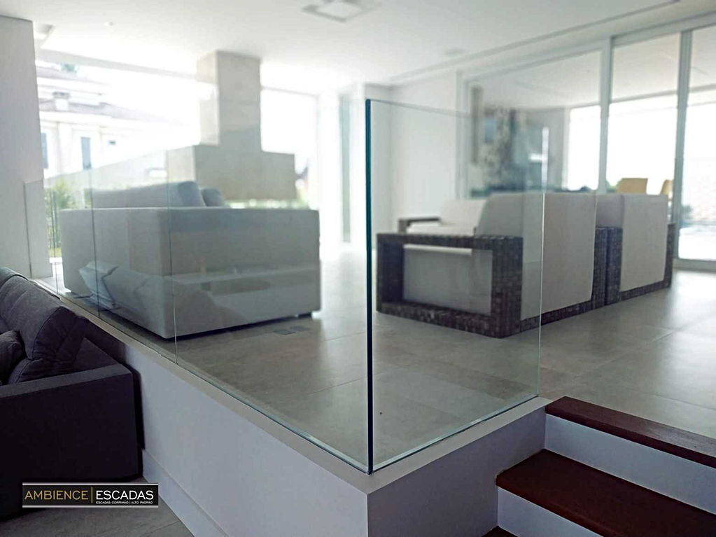 Guarda corpo em vidro laminado 12 mm embutido em calhas de aço inox. em piso de mezanino. Guarda corpo instalado em residencia de condomínio de Aldeia da Serra em São Paulo.
