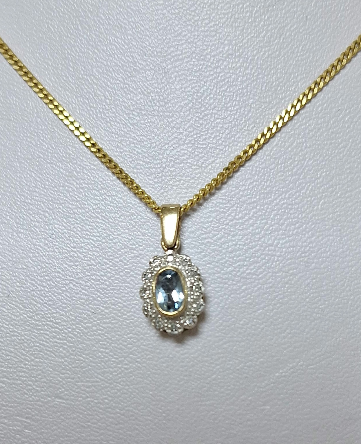 G93.  9ct yellow gold topaz and diamond pendant and chain ĺ