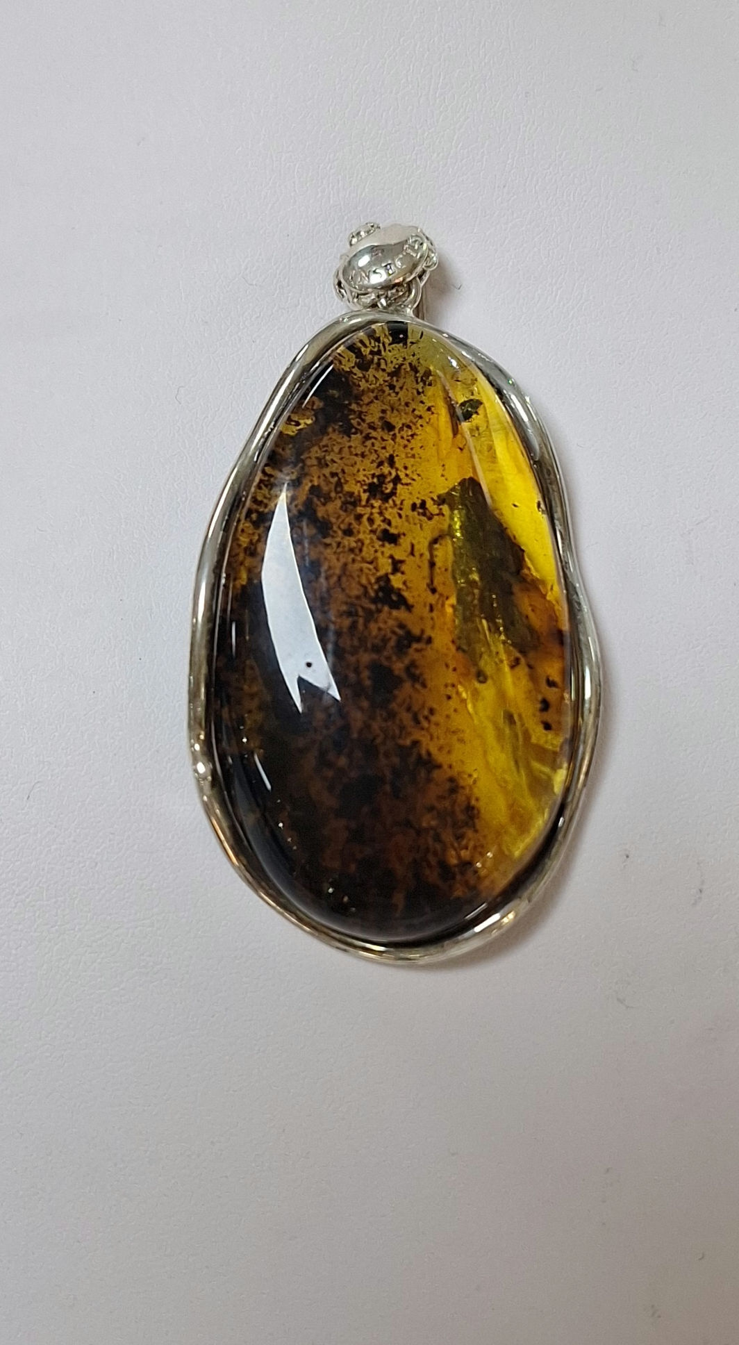 S74.  Baltic Amber and Sterling Silver Pendant with inclusions 