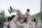 Groomsmen trhwoing the groom in the air