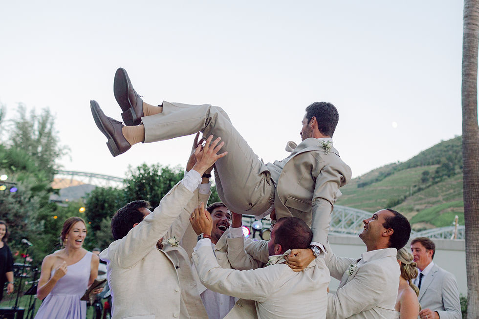 Groomsmen trhwoing the groom in the air