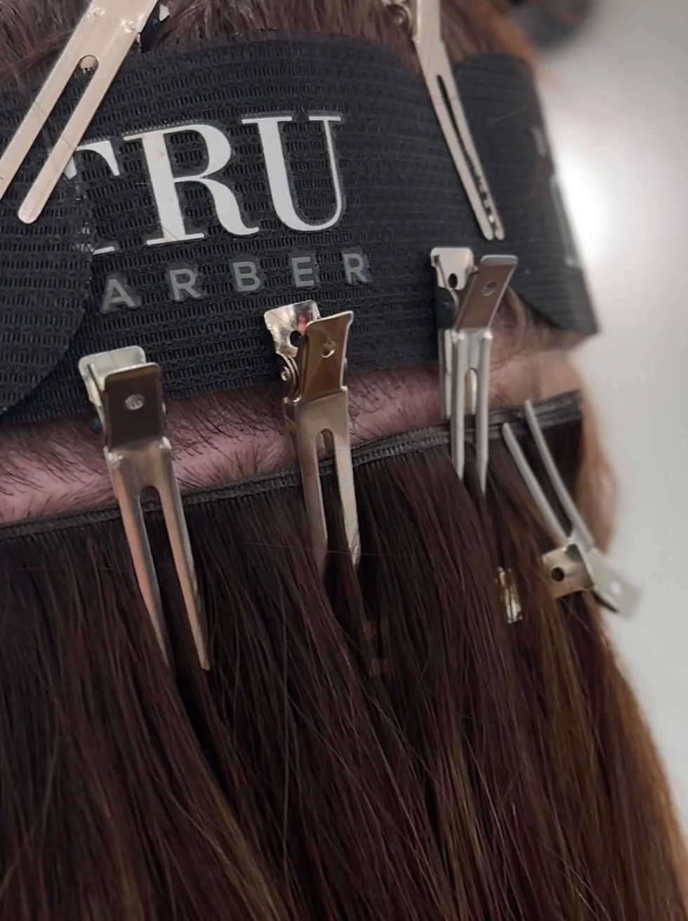 Eye-level view of hair extensions laid out on a wooden table