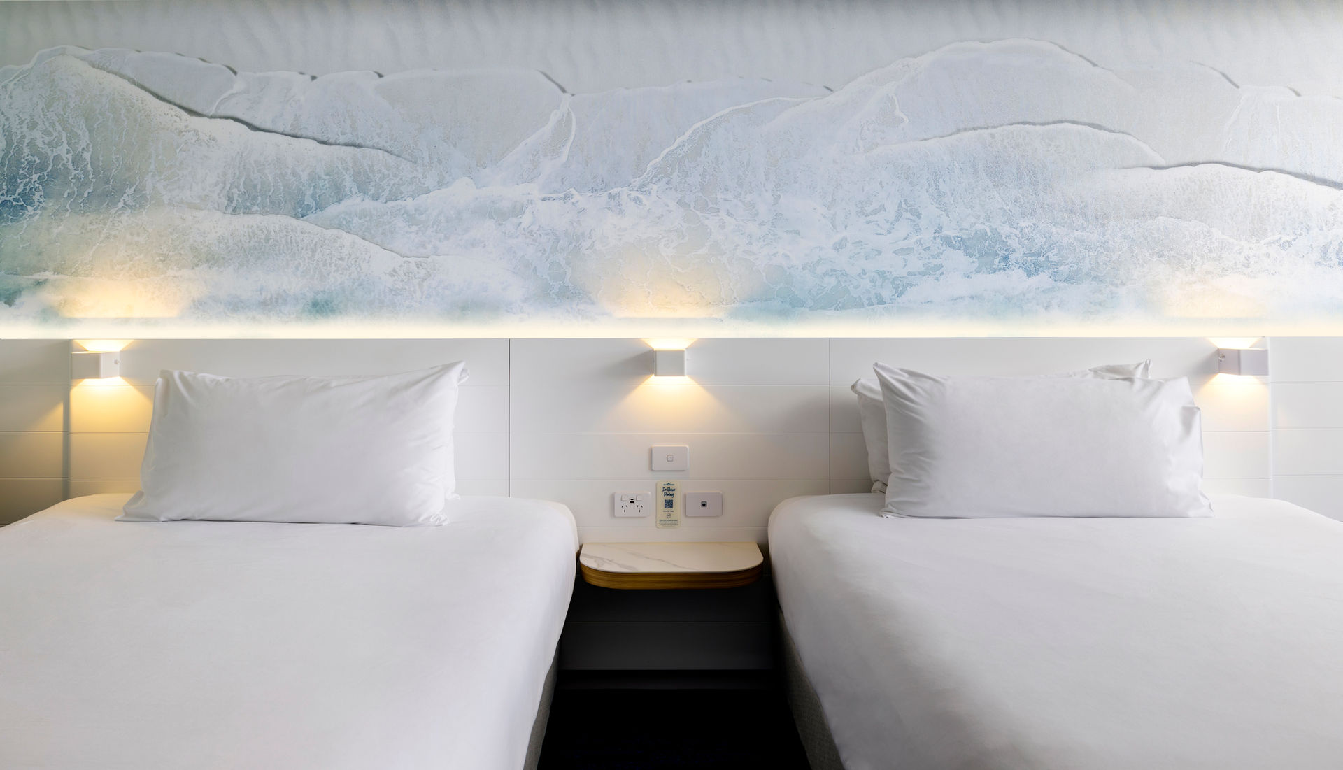 Carmody's vision was to emulate the journey of the ocean, starting from the deep blue waves, flowing into greens and light blues, and finishing with sandy tones as the carpet transitions to the hard flooring. The result? A seamless visual narrative that echoes the tranquil beauty of Sea World Resort’s surroundings.