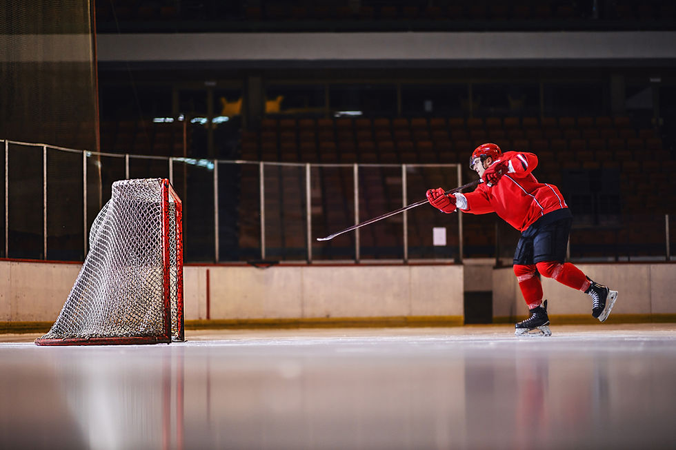 motivated-hockey-player-training-shooting-goal-while-skating-ice