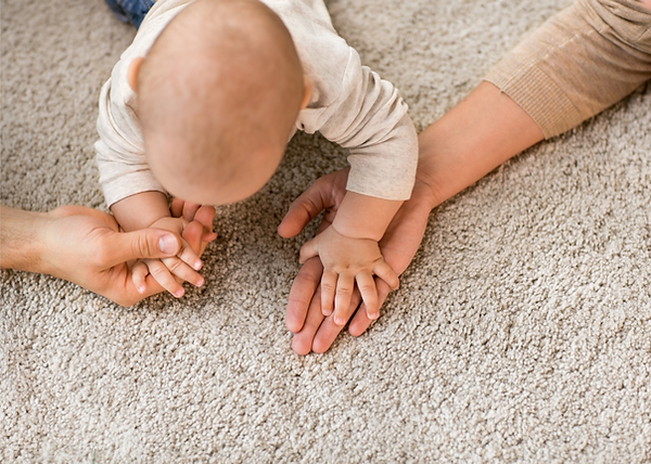 baby over light cozy carpet