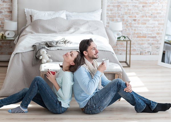 couple drinking coffee sitting on laminate floors