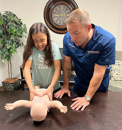 David Smith training a client in infant CPR