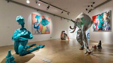 A museum gallery showcasing commercial contemporary pop art, illustrating the modern shift from fine art to superficial interior decoration.