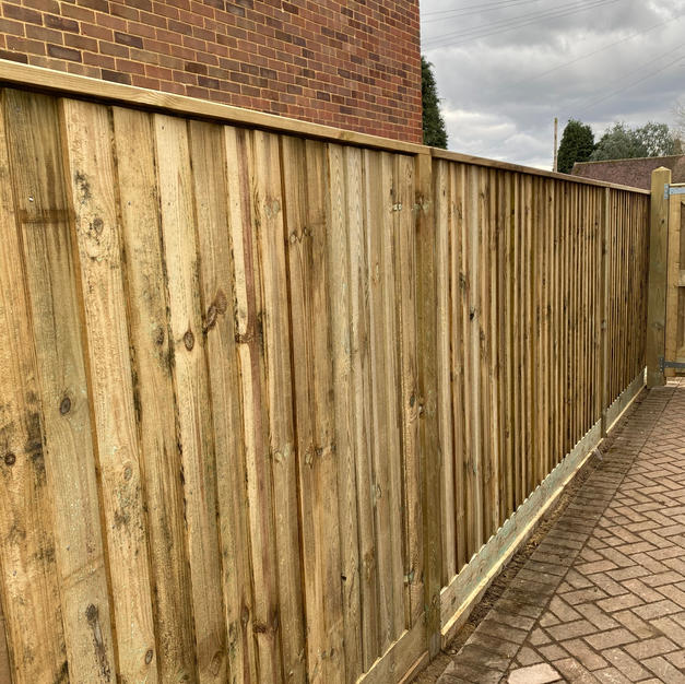 Featheredge fencing with sleeper walls in Warfield.
