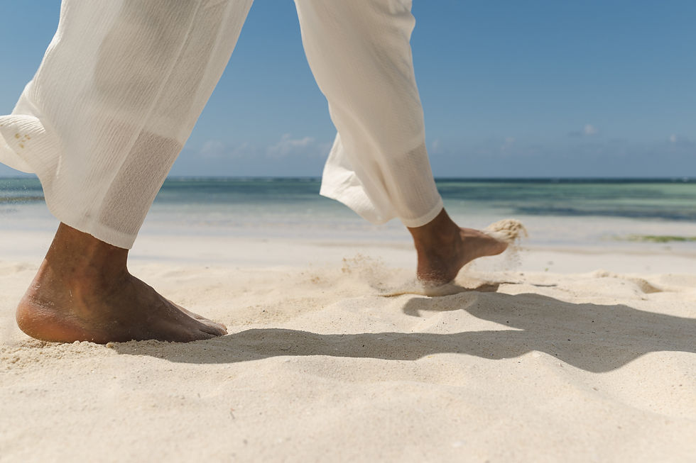 Barefoot walk on white sand beach in Zanzibar, luxury travel and lifestyle photography by Michal Dzikowski