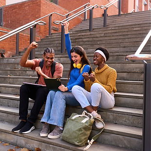 Students cheering on campus stairs during identity tour.
