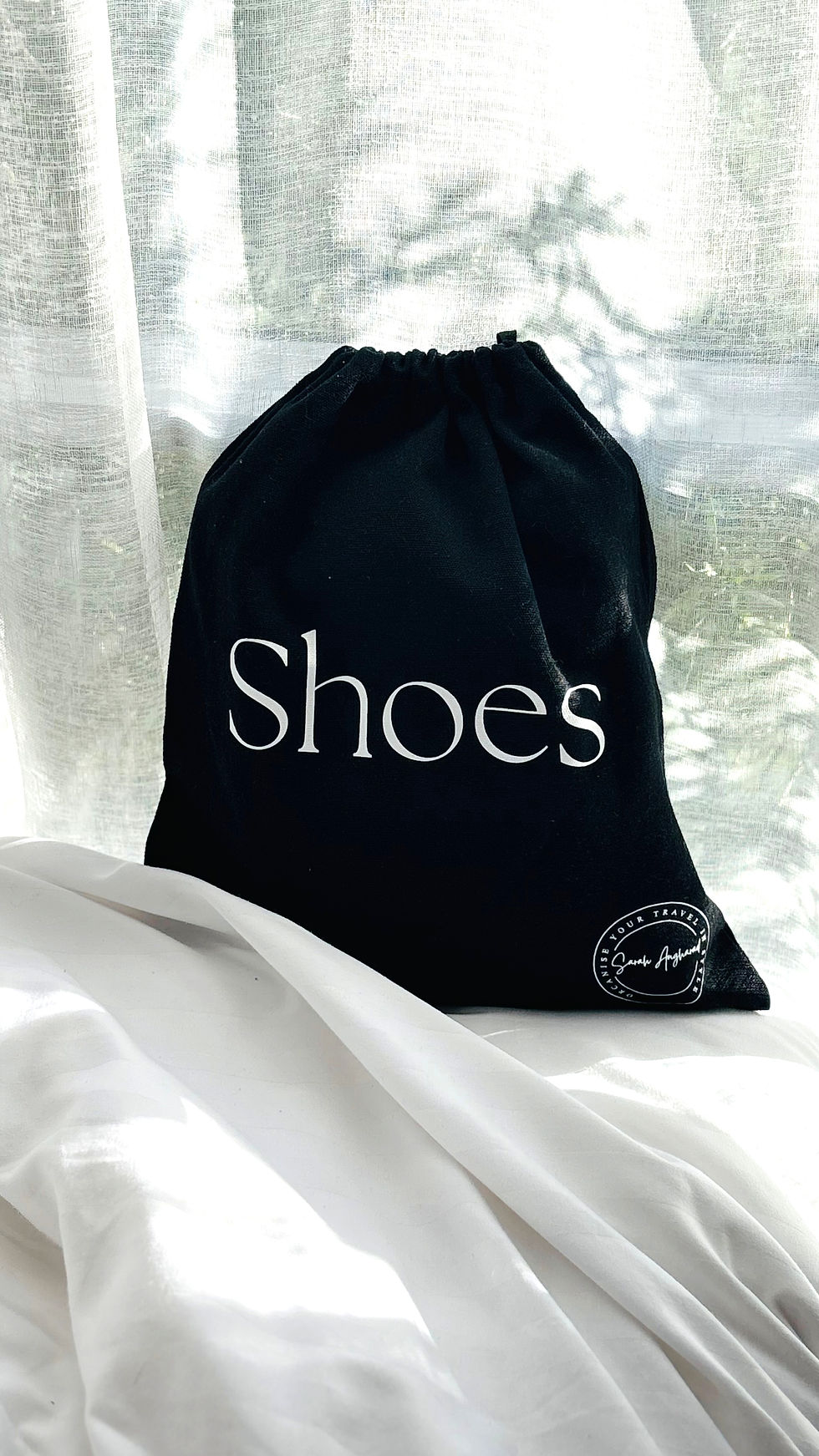 Black Travel Shoes Bag pictured on hotel bed