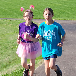 Two girls participating in "Girls on the Run,” which is one of the many community impact programs that United Way helps out with.