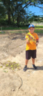 Elian holding rebar from the tee ball field
