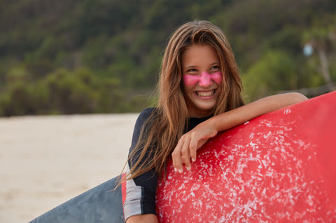photo-pleasant-looking-european-woman-with-happy-expression-rejoices-day-surfing-holds-wax