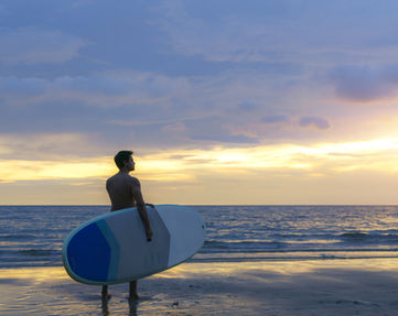 asian-man-holding-sup-board-paddle-walking-beach-background-ocean.jpg
