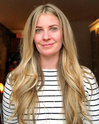 Woman with long blonde hair smiling for the camera.