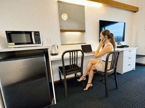 Woman working on laptop in a Gisborne motel room