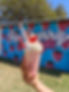 A strawberry specialty shake infront of the Rockberry Ranch mural with strawberries.