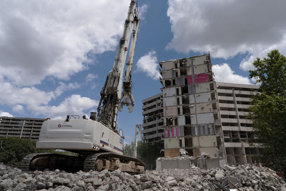 Excavators in front of a high rise in Le Mirail, Toulouse