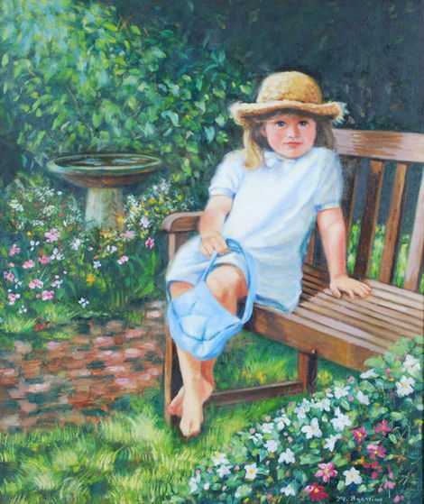 Portrait: girl in straw hat sits on a bench in a garden