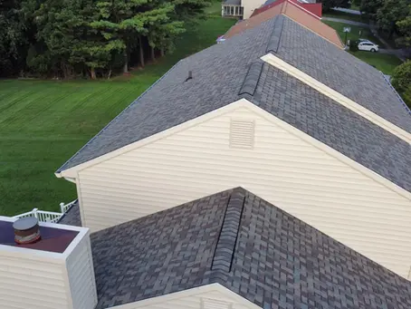 photo-aerial-view-of-house-with-new-shingle-roof-and-chimney-illustrating-what-to-do-before-signing-a-roofing-contract-with-clean-yard-and-siding