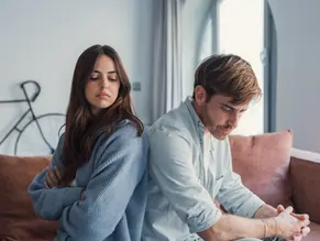 man and woman sitting on a couch