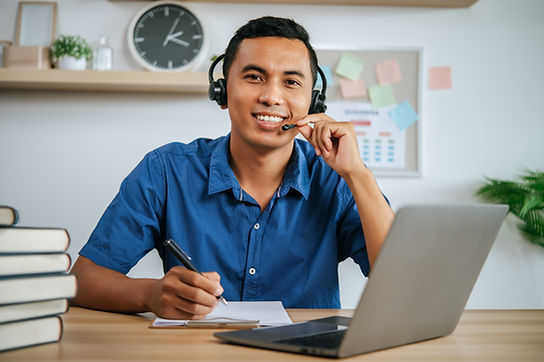 man-with-headphones-working-office-with-papers-laptop-desk.jpg