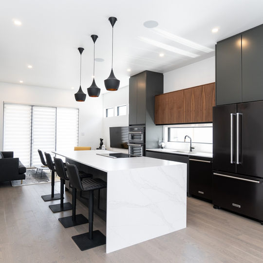 Bold black cabinets, sleek white countertops and warm chocolate wood accents form a stunning, contemporary kitchen design from Imperial Cabinet in Winnipeg, Manitoba.